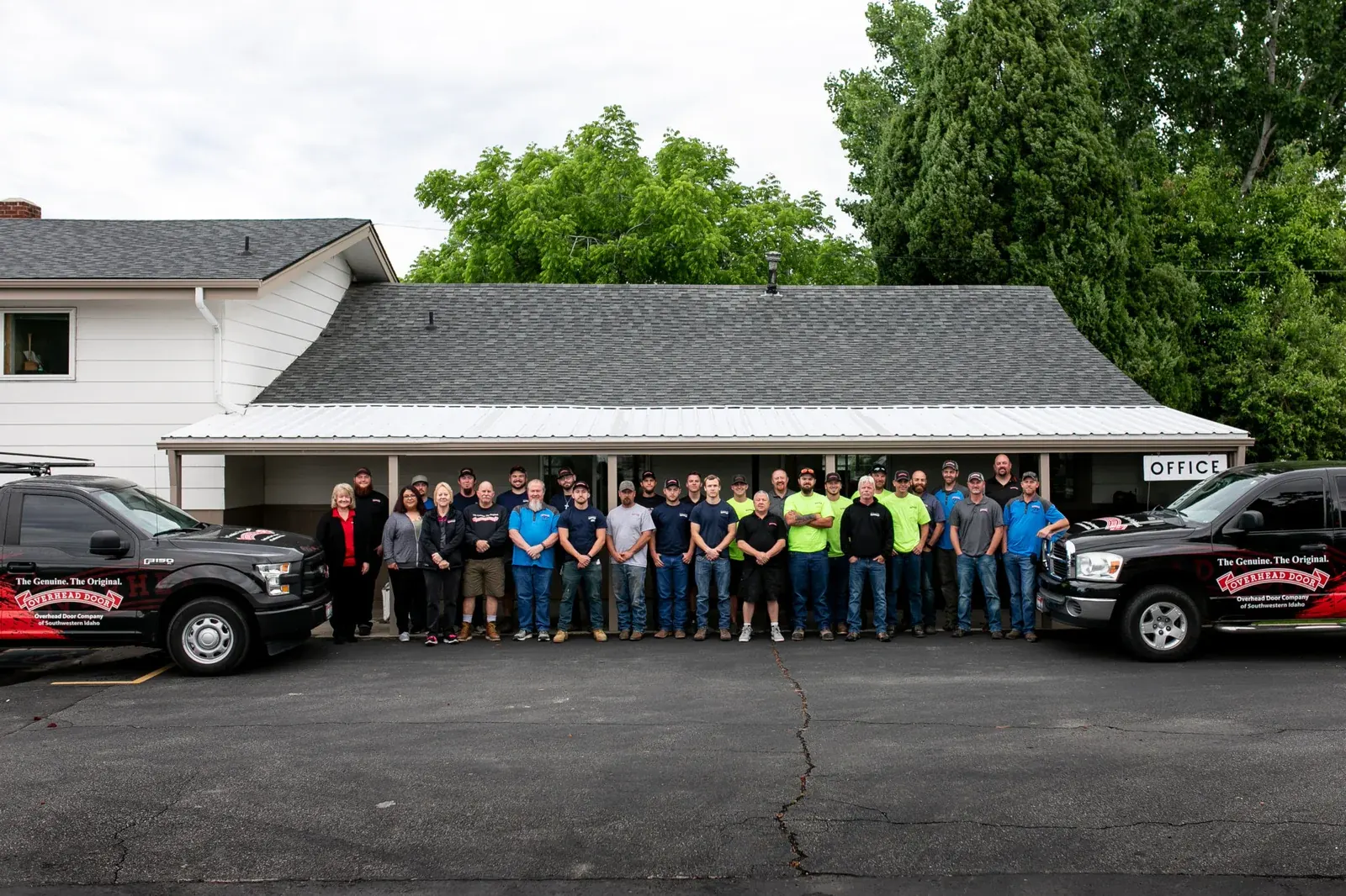 The Overhead Door Company of Southwestern Idaho team with service trucks outside the office