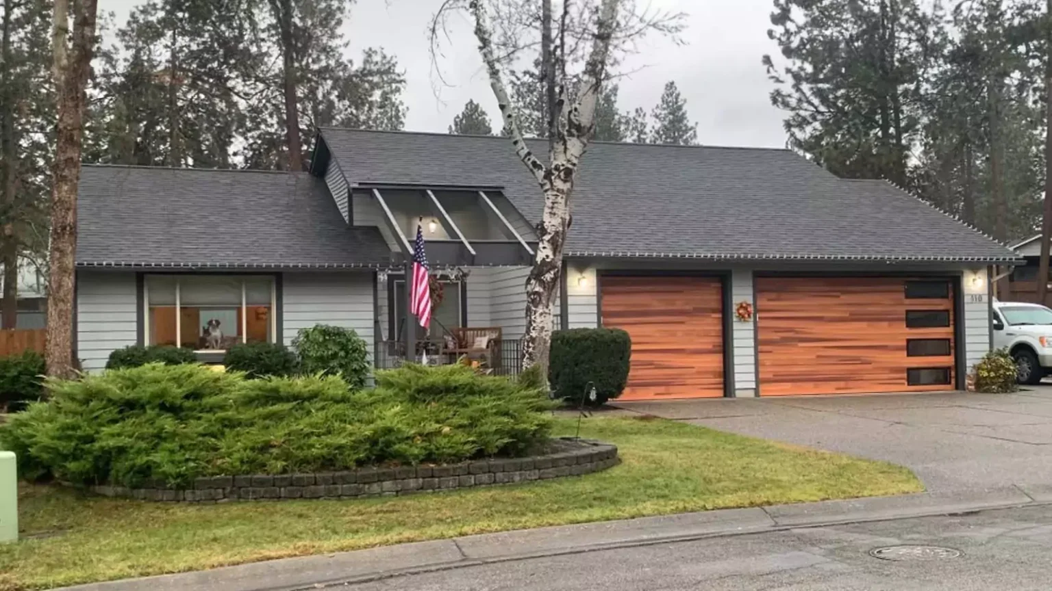 Wood-look double garage doors installed on a home by Overhead Door Company