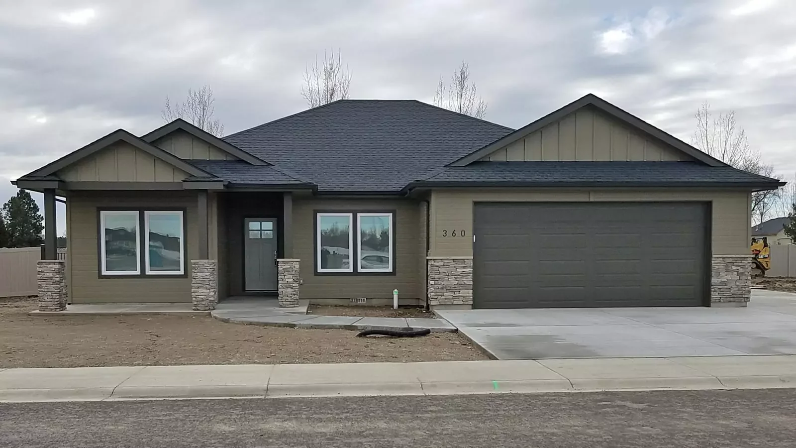 Custom garage doors on a timber home installed by Overhead Door Company